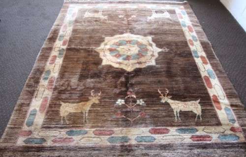 A stylish & unusual brown Iranian Meshkin Persian Carpet w/ deer motifs & centre medallion