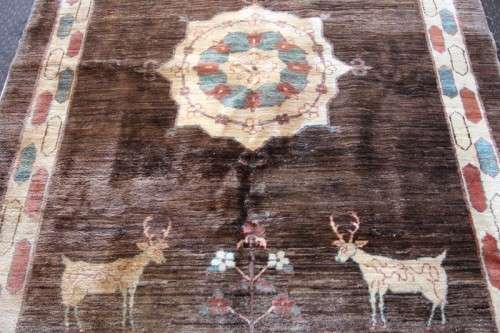 A stylish & unusual brown Iranian Meshkin Persian Carpet w/ deer motifs & centre medallion