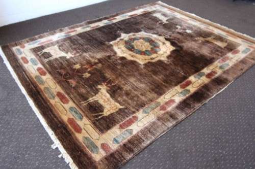 A stylish & unusual brown Iranian Meshkin Persian Carpet w/ deer motifs & centre medallion