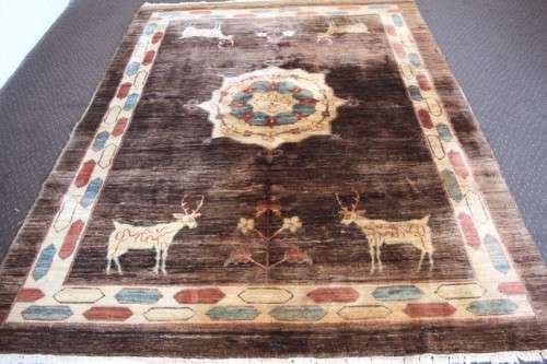 A stylish & unusual brown Iranian Meshkin Persian Carpet w/ deer motifs & centre medallion