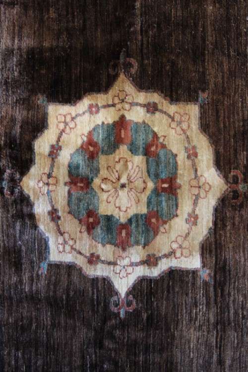 A stylish & unusual brown Iranian Meshkin Persian Carpet w/ deer motifs & centre medallion