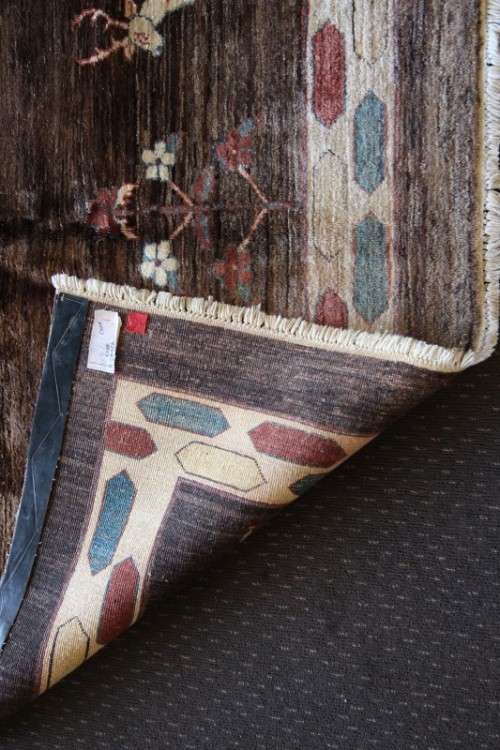 A stylish & unusual brown Iranian Meshkin Persian Carpet w/ deer motifs & centre medallion