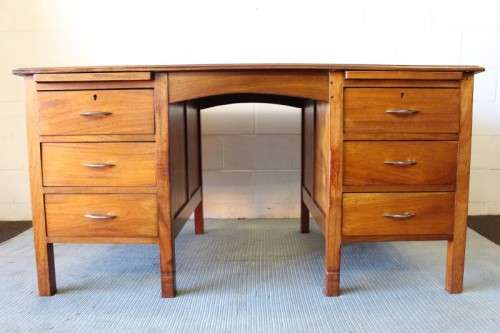 A beautiful vintage 6-drawer solid teak knee-hole partners desk with pull-out writing tops
