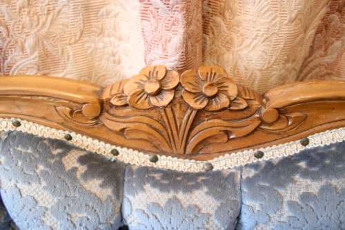 2 beautiful, elegant carved Victorian sofas with deep button detailing and blue period style fabric.