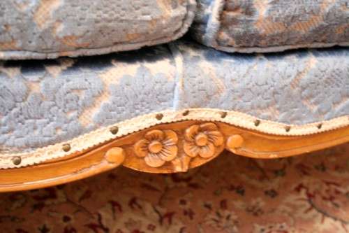 2 beautiful, elegant carved Victorian sofas with deep button detailing and blue period style fabric.