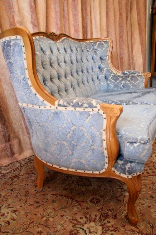 2 beautiful, elegant carved Victorian sofas with deep button detailing and blue period style fabric.