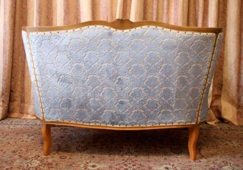 2 beautiful, elegant carved Victorian sofas with deep button detailing and blue period style fabric.