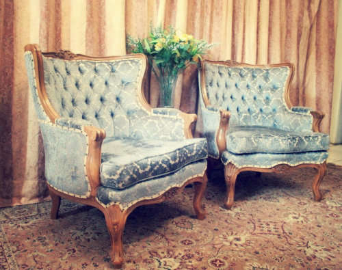 Two elegant hand carved Victorian arm chairs with deep button detailing & gorgeous blue fabric.