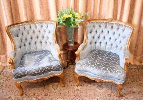 Two elegant hand carved Victorian arm chairs with deep button detailing & gorgeous blue fabric.
