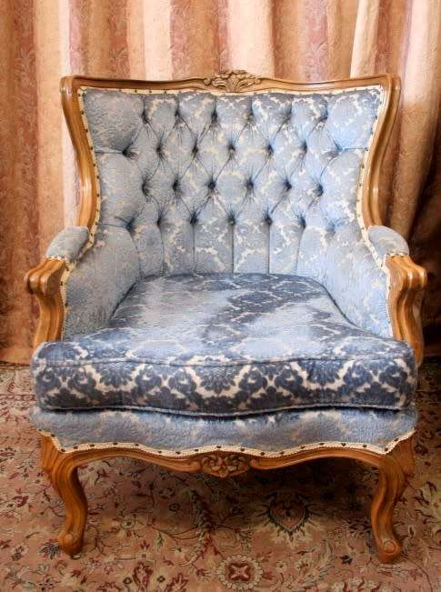 Two elegant hand carved Victorian arm chairs with deep button detailing & gorgeous blue fabric.