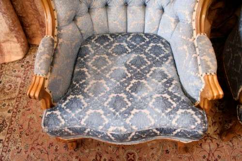 Two elegant hand carved Victorian arm chairs with deep button detailing & gorgeous blue fabric.