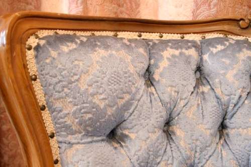 Two elegant hand carved Victorian arm chairs with deep button detailing & gorgeous blue fabric.