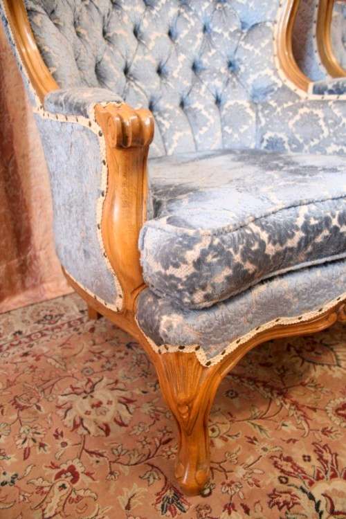 Two elegant hand carved Victorian arm chairs with deep button detailing & gorgeous blue fabric.