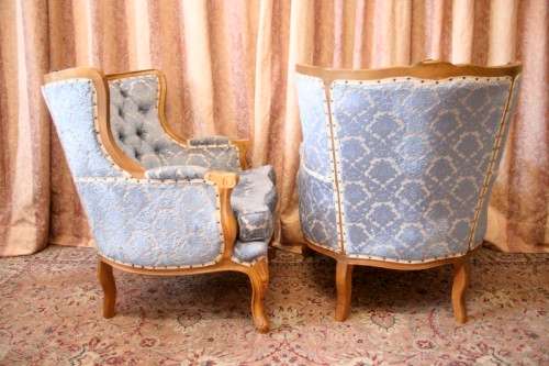 Two elegant hand carved Victorian arm chairs with deep button detailing & gorgeous blue fabric.