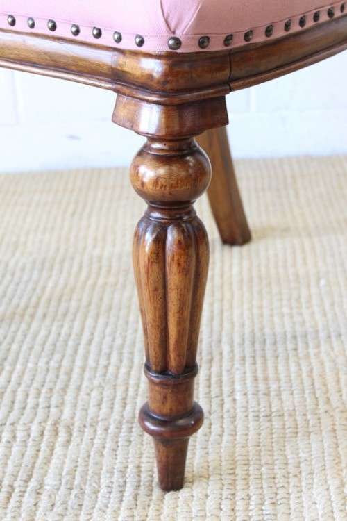 A beautifully upholstered antique Victorian solid mahogany carved balloon-back occasional chair