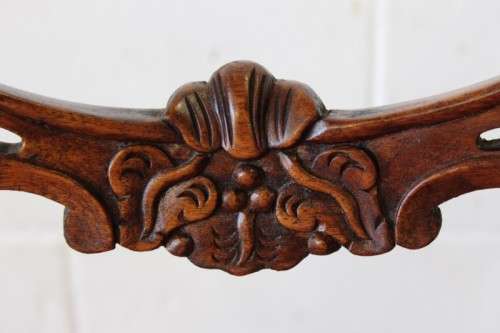 A beautifully upholstered antique Victorian solid mahogany carved balloon-back occasional chair