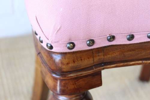 A beautifully upholstered antique Victorian solid mahogany carved balloon-back occasional chair