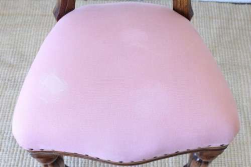 A beautifully upholstered antique Victorian solid mahogany carved balloon-back occasional chair
