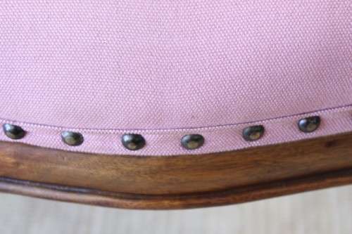 A beautifully upholstered antique Victorian solid mahogany carved balloon-back occasional chair