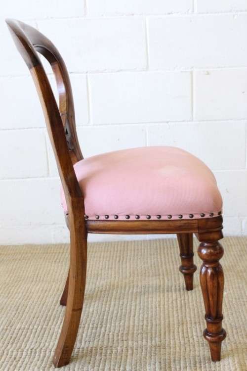A beautifully upholstered antique Victorian solid mahogany carved balloon-back occasional chair