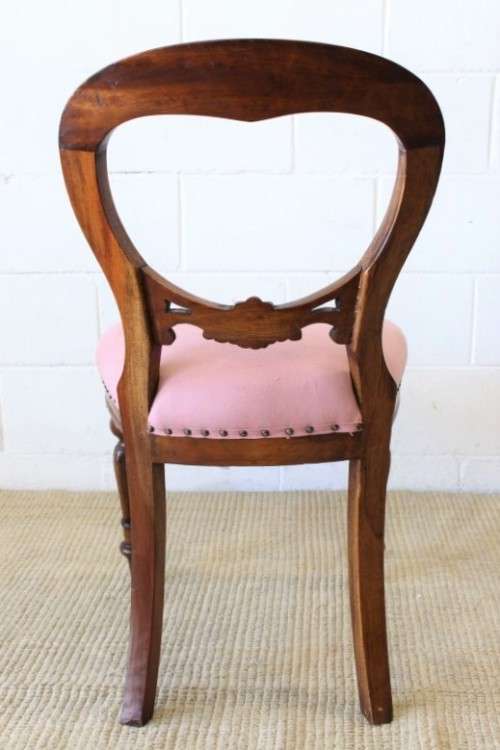 A beautifully upholstered antique Victorian solid mahogany carved balloon-back occasional chair