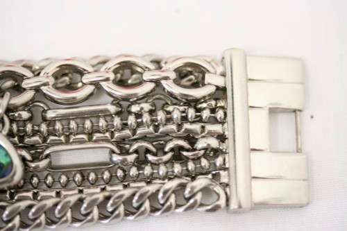 A stunning "GUESS" ladies wrist watch with patterned chains and coloured stone charms.
