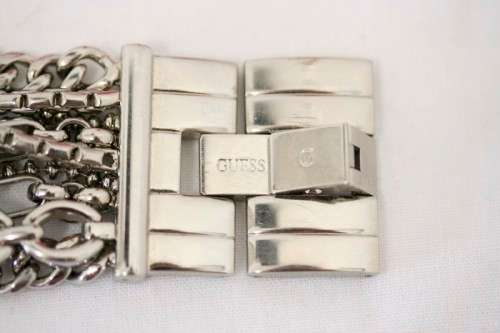 A stunning "GUESS" ladies wrist watch with patterned chains and coloured stone charms.