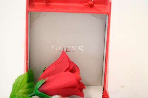 A stunning "GUESS" ladies wrist watch with patterned chains and coloured stone charms.