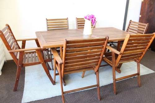 A fabulous 6-seater solid Sapele wood, all weather "Outback" outdoor patio table with 6 armchairs