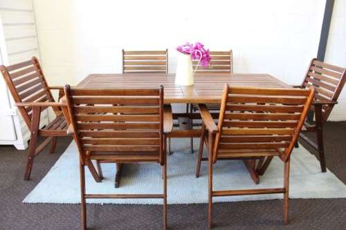 A fabulous 6-seater solid Sapele wood, all weather "Outback" outdoor patio table with 6 armchairs