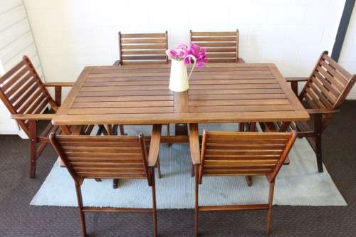 A fabulous 6-seater solid Sapele wood, all weather "Outback" outdoor patio table with 6 armchairs
