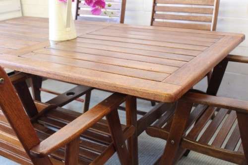 A fabulous 6-seater solid Sapele wood, all weather "Outback" outdoor patio table with 6 armchairs