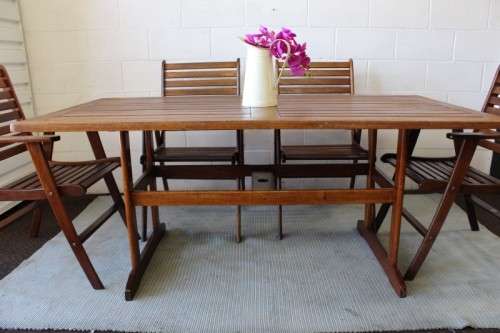 A fabulous 6-seater solid Sapele wood, all weather "Outback" outdoor patio table with 6 armchairs