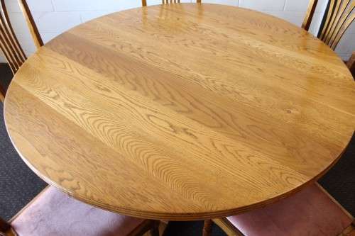 A wonderful solid Oak dining suite with a large round table and 5x upholstered chairs