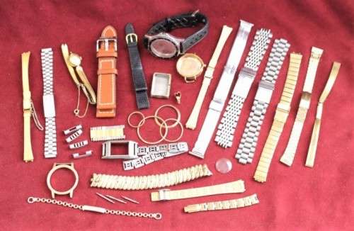 An incredible collection of assorted watchmaker spares including straps, links, bezels and more