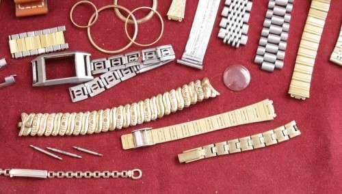 An incredible collection of assorted watchmaker spares including straps, links, bezels and more