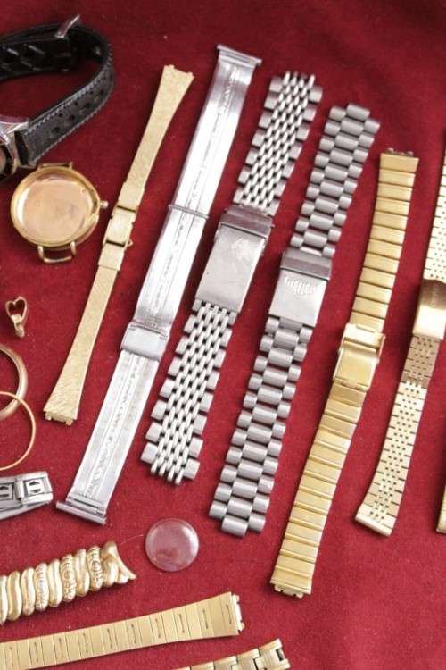 An incredible collection of assorted watchmaker spares including straps, links, bezels and more