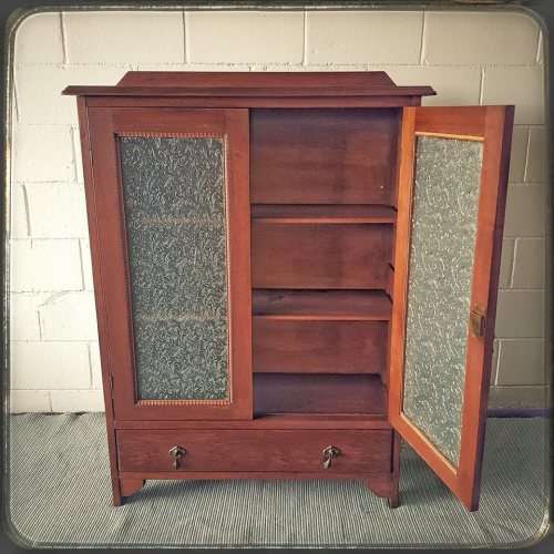 An amazing vintage Teak bookcase/ cabinet with decorative frosted glass doors and a bottom drawer!