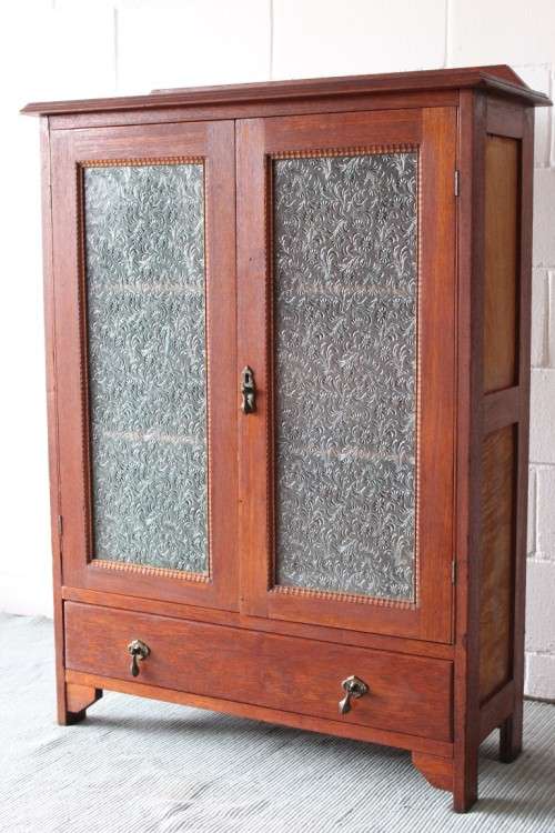 An amazing vintage Teak bookcase/ cabinet with decorative frosted glass doors and a bottom drawer!