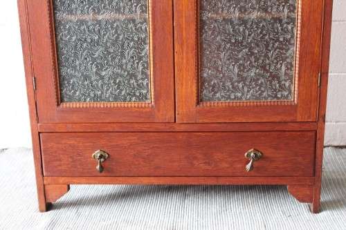 An amazing vintage Teak bookcase/ cabinet with decorative frosted glass doors and a bottom drawer!