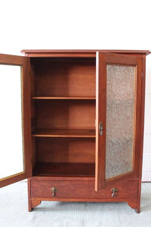 An amazing vintage Teak bookcase/ cabinet with decorative frosted glass doors and a bottom drawer!