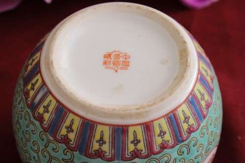 A beautiful and detailed jade-green oriental ginger jar & lid with hand painted symbols and flowers