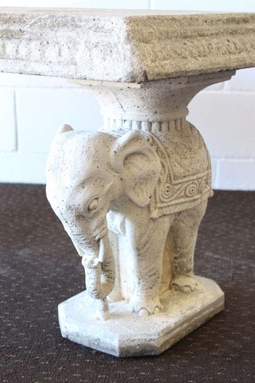 A gorgeous solid concrete outdoor garden bench with beautifully detailed "elephant" leg supports