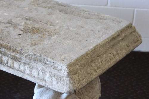 A gorgeous solid concrete outdoor garden bench with beautifully detailed "elephant" leg supports