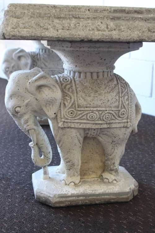A gorgeous solid concrete outdoor garden bench with beautifully detailed "elephant" leg supports