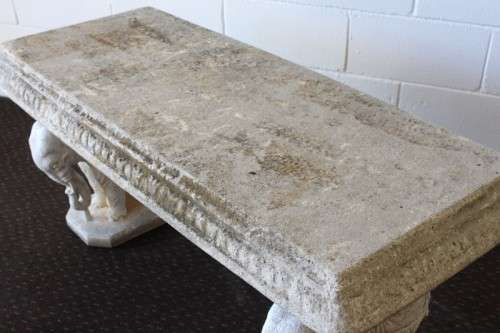 A gorgeous solid concrete outdoor garden bench with beautifully detailed "elephant" leg supports