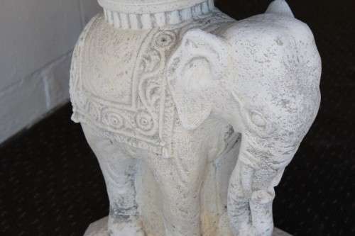 A gorgeous solid concrete outdoor garden bench with beautifully detailed "elephant" leg supports