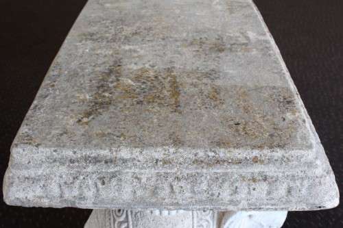 A gorgeous solid concrete outdoor garden bench with beautifully detailed "elephant" leg supports