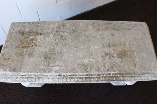 A gorgeous solid concrete outdoor garden bench with beautifully detailed "elephant" leg supports