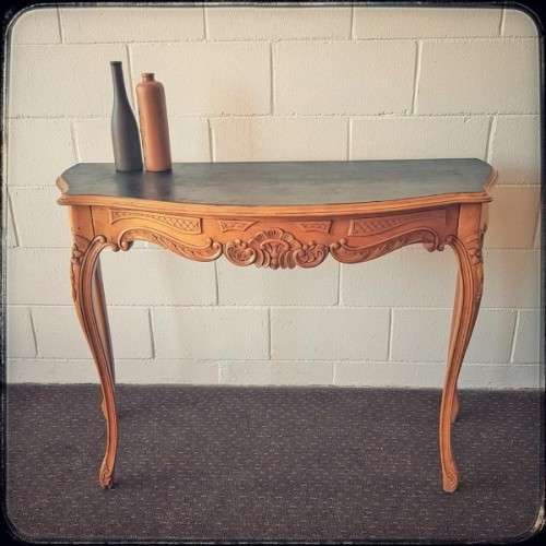 A beautiful ornately carved Yew wood console/ hall table with an ebony stained top on cabriole legs